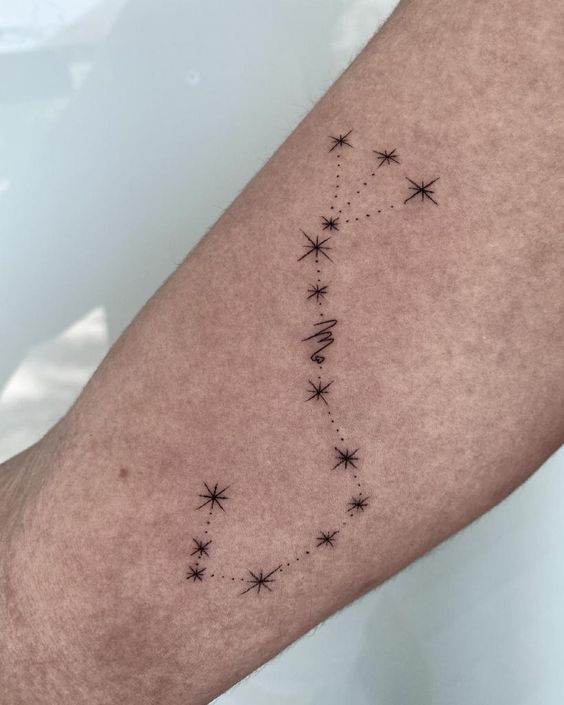 Tattoo of the constellation sign of the zodiac Scorpio on the forearm