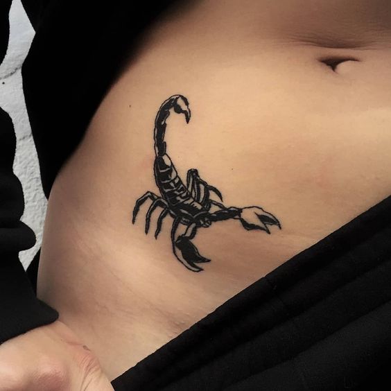 Tattoo of the zodiac sign of the scorpion on the stomach for women