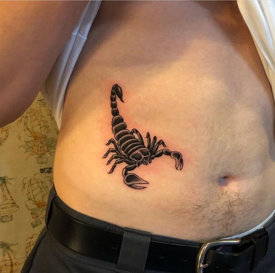 Tattoo of the zodiac sign of a scorpion on the stomach for men