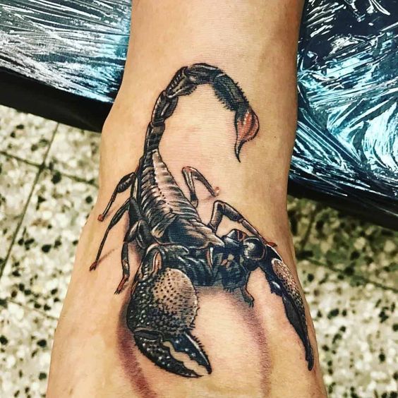 Tattoo of the zodiac sign of the scorpion on the ankle for women