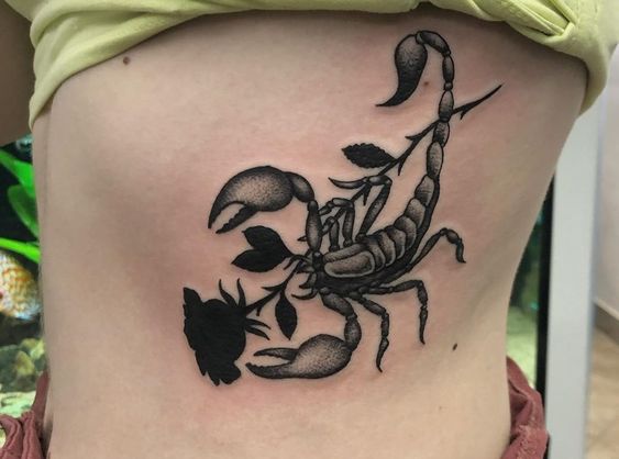 Tattoo of the zodiac sign of the scorpion on the stomach for women