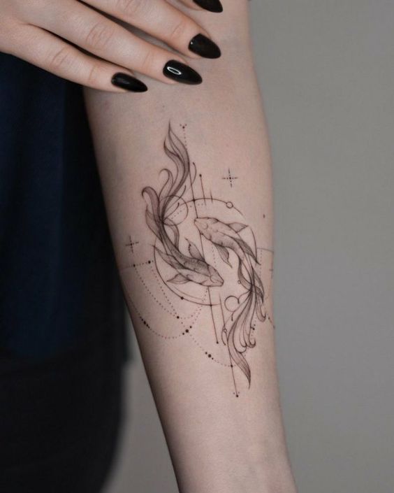 Tattoo of the fish zodiac sign on the forearm for women