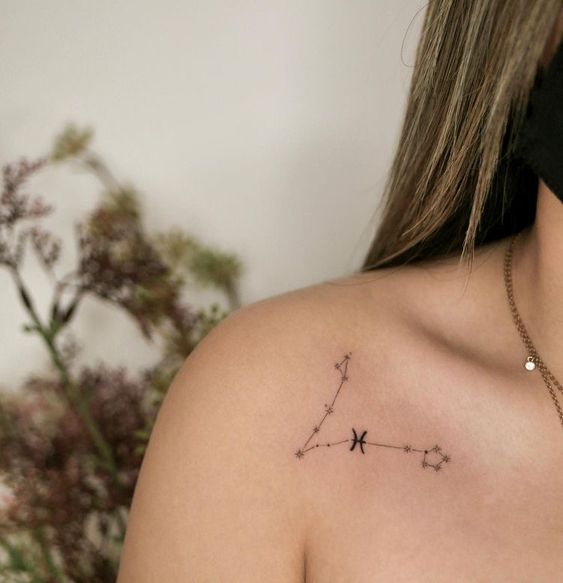 Tattoo the constellation sign of the zodiac fish on the shoulder for women