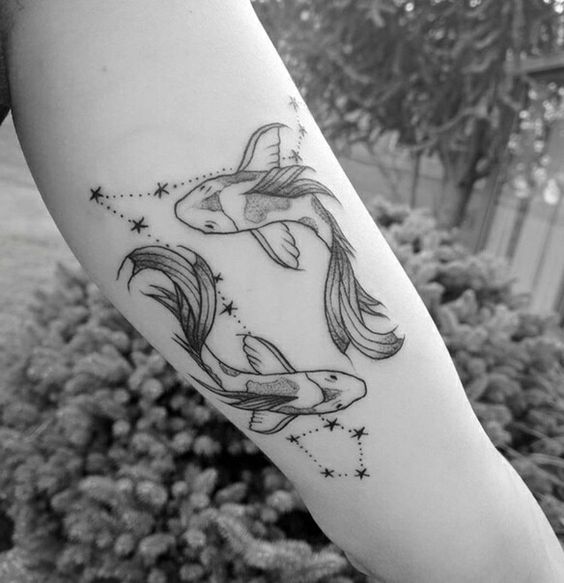 Tattoo the constellation sign of the zodiac fish on the arm for women