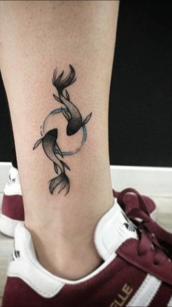 Tattoo of the zodiac sign of a fish on the shin for men