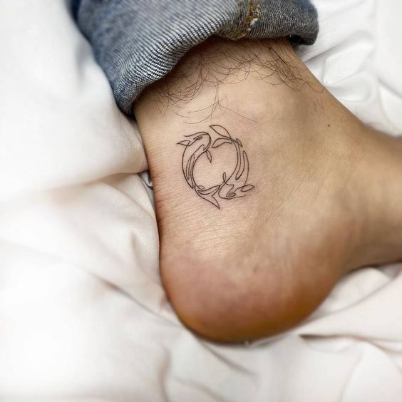 Tattoo of the zodiac sign of a fish on the ankle for men