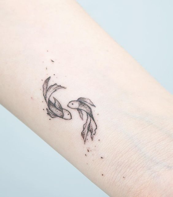 Tattoo of the zodiac sign of a fish on the arm