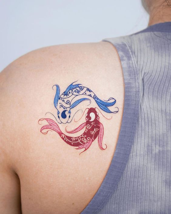 Fish zodiac sign tattoo on the shoulder blade for women