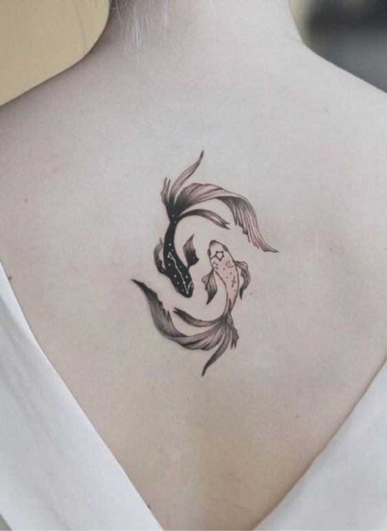 Tattoo of the fish zodiac sign on the back for women