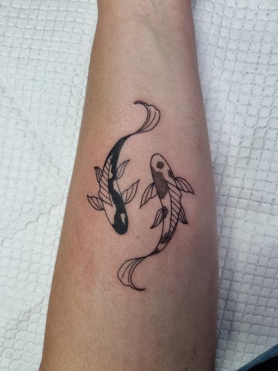 Tattoo of the zodiac sign of a fish on the forearm for men