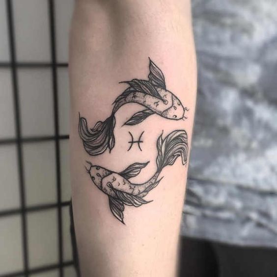 Tattoo of the zodiac sign fish on the forearm for men