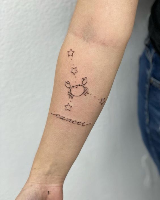 Tattoo of the zodiac sign Cancer on the forearm for women