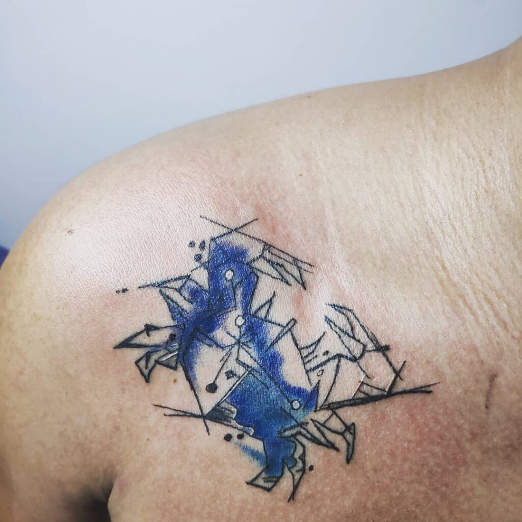 Tattoo of the zodiac sign of Cancer on the collarbone for men