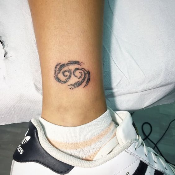 Zodiac sign cancer tattoo on the shin for women