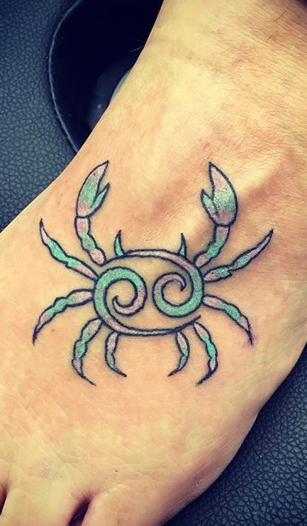 Tattoo of the zodiac sign of Cancer on the foot