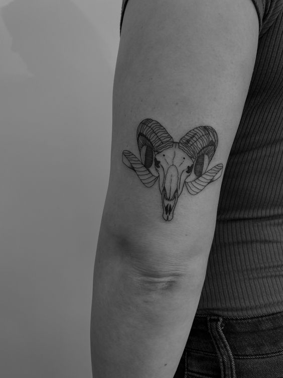 Tattoo of the zodiac sign Aries on the shoulder for women