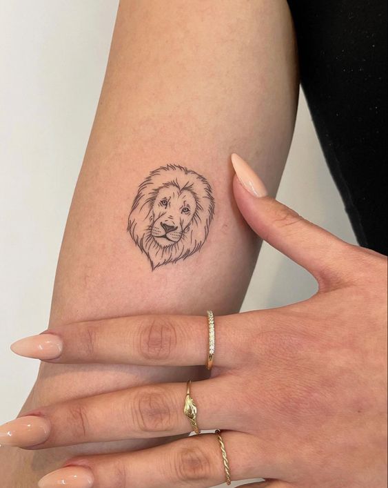 Tattoo of the zodiac sign lion on the shoulder for women