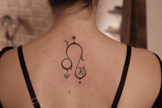 Tattoo symbol of the zodiac sign lion on the back for women