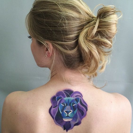 Tattoo of the zodiac sign lion on the back for women