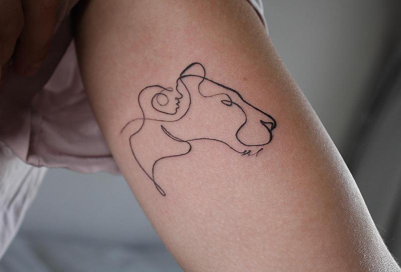 Tattoo of the zodiac sign lion on the arm