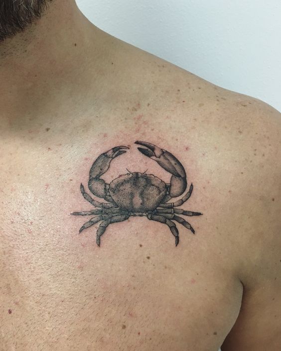 Tattoo of the zodiac sign of Cancer on the collarbone for men