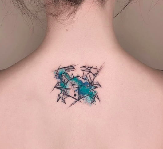 Tattoo of the zodiac sign crab on the back for women