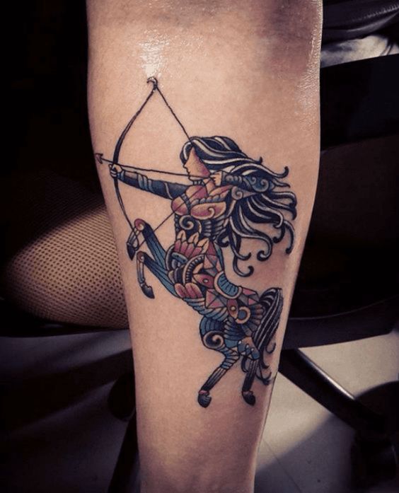 Tattoo of the zodiac sign Sagittarius on the leg for women