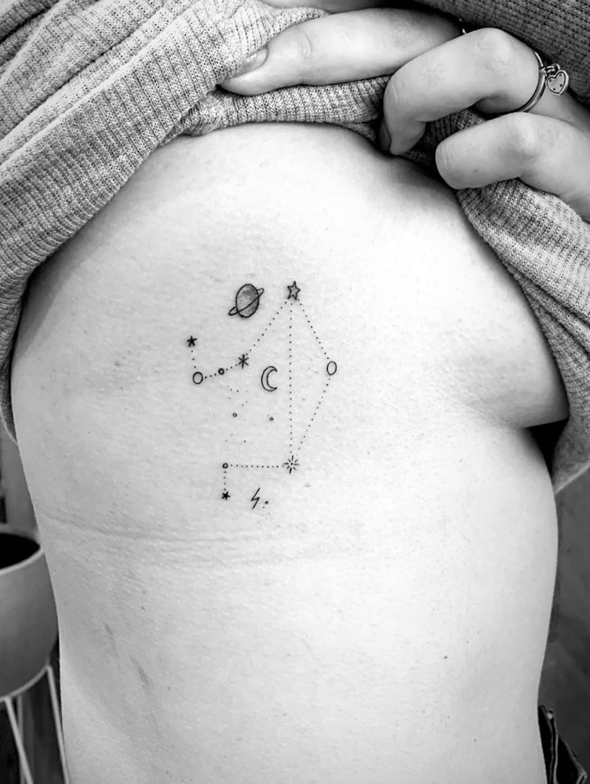 Tattoo the constellation sign of the zodiac Libra on the side for women