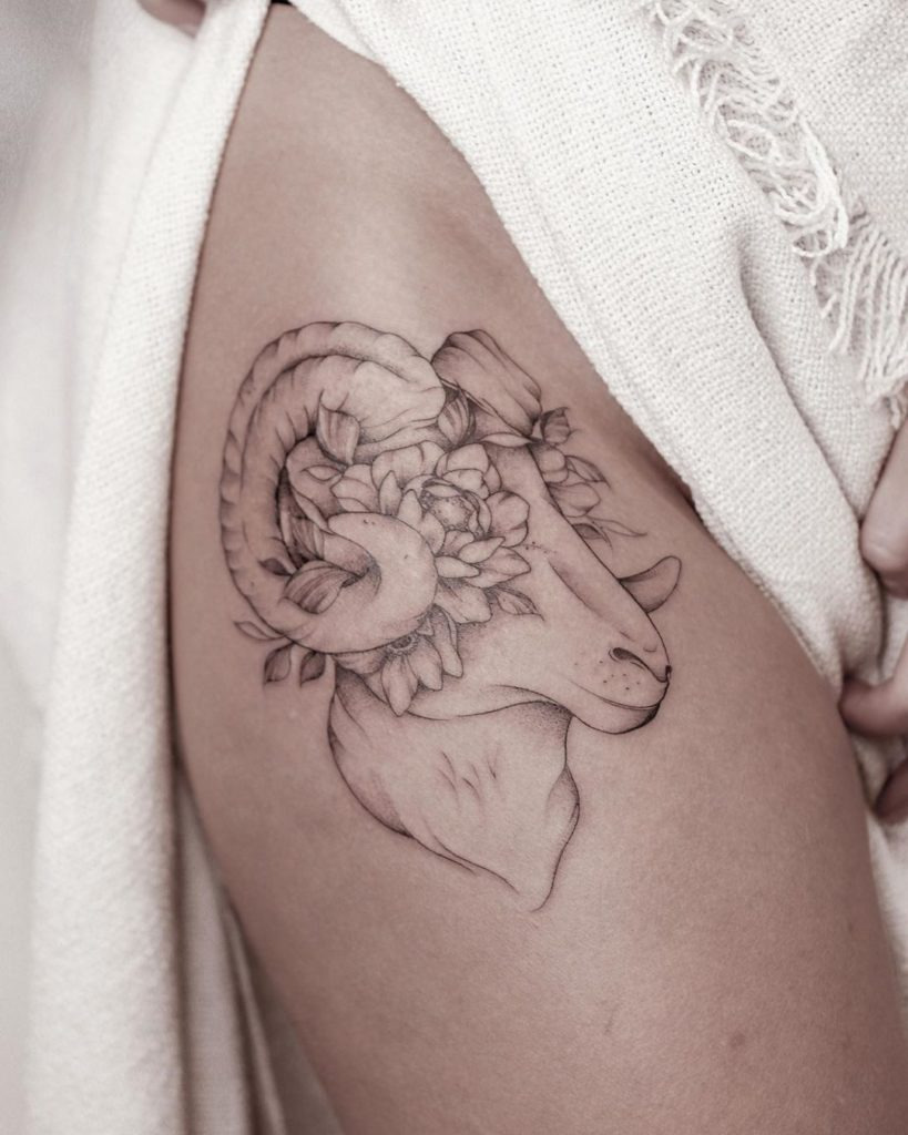 Tattoo of the zodiac sign Aries on the hip for women