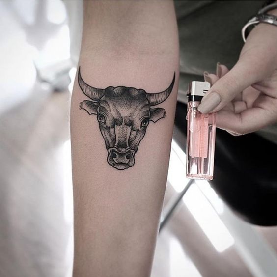 Bull tattoo on forearm for women