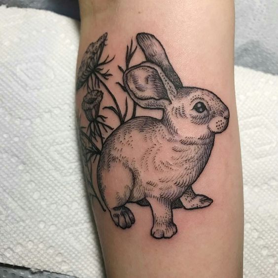 Tattoo of a hare (rabbit) on the shoulder for women