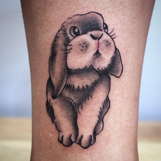 Tattoo of a hare (rabbit) on the shin for women