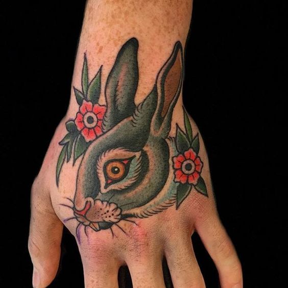 Tattoo of a hare (rabbit) on the hand for men