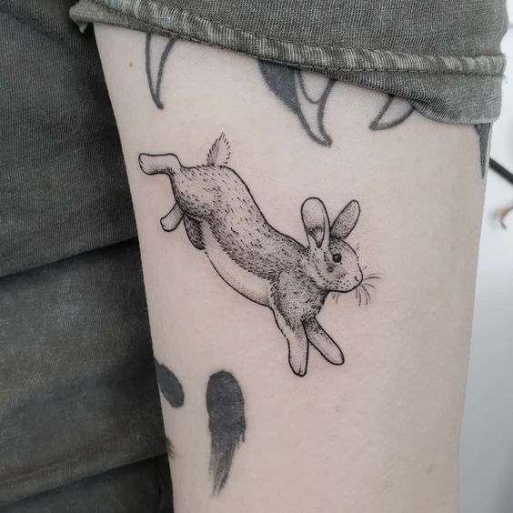 Tattoo of a hare (rabbit) on the shoulder for women