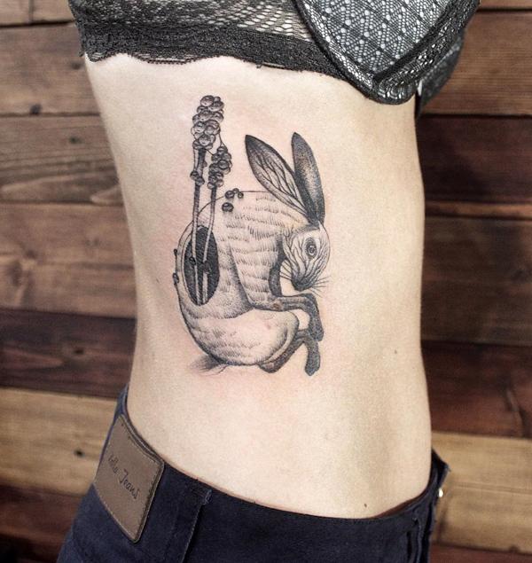 Tattoo of a hare (rabbit) on the side for women