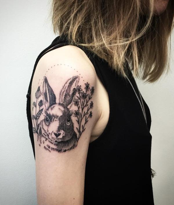 Tattoo of a hare (rabbit) on the shoulder for women