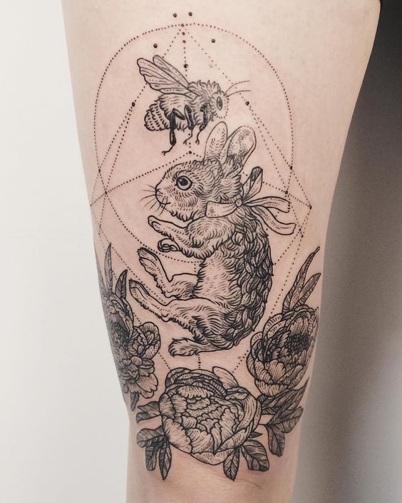 Tattoo of a hare (rabbit) on the hip for women