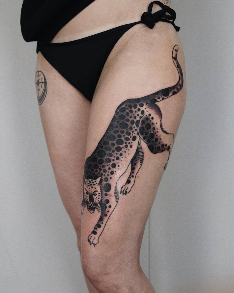 Cheetah tattoo on the hip for women