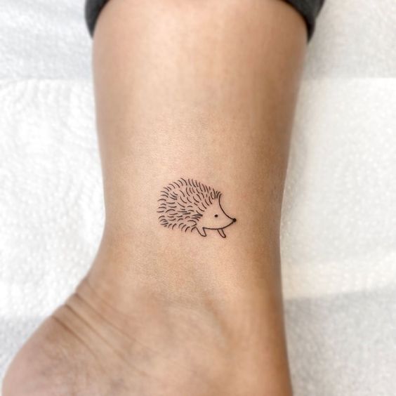 Tattoo of a hedgehog on the lower leg for women