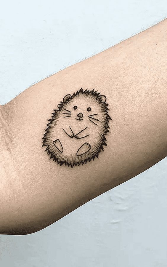 Tattoo of a hedgehog on the shoulder for women