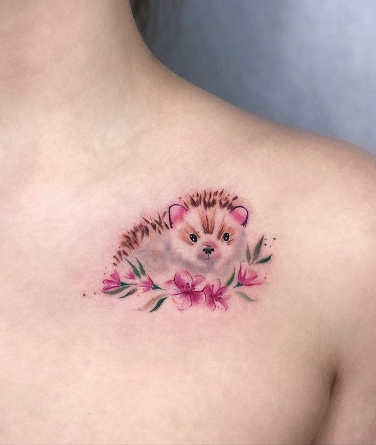 Tattoo of a hedgehog on the collarbone for women