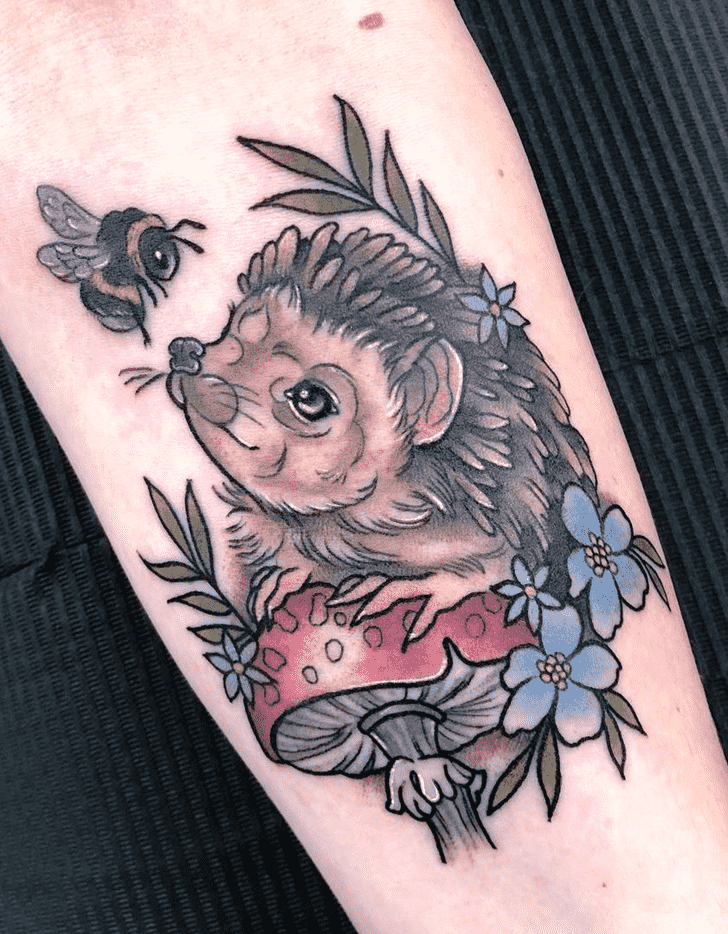 Tattoo of a hedgehog on the forearm for women