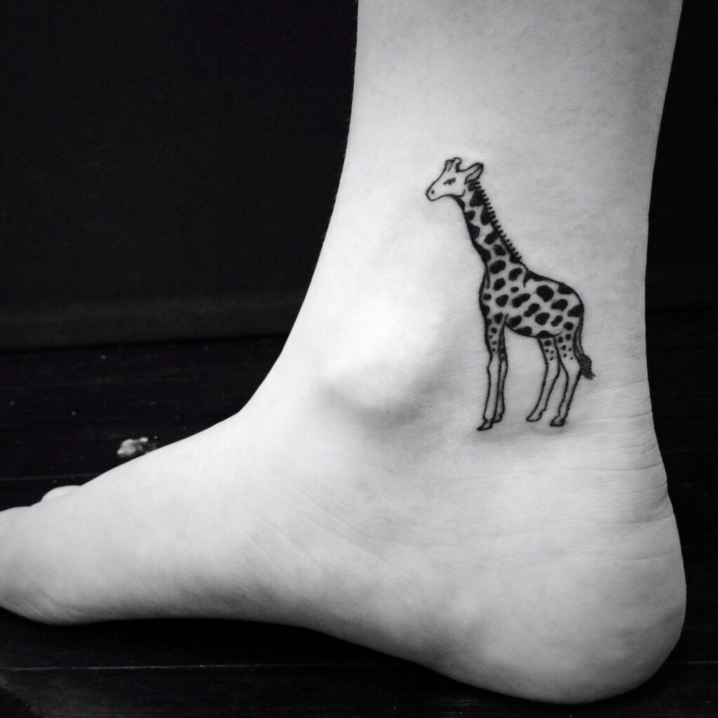 Tattoo of a giraffe on the ankle for women