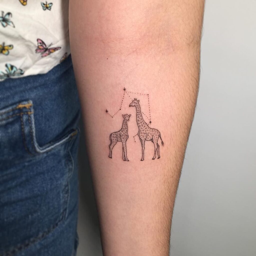 Tattoo of a giraffe on the forearm for women