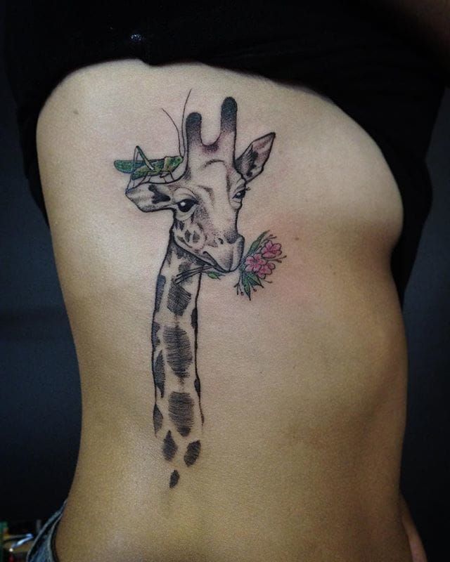 Tattoo of a giraffe on the side for women