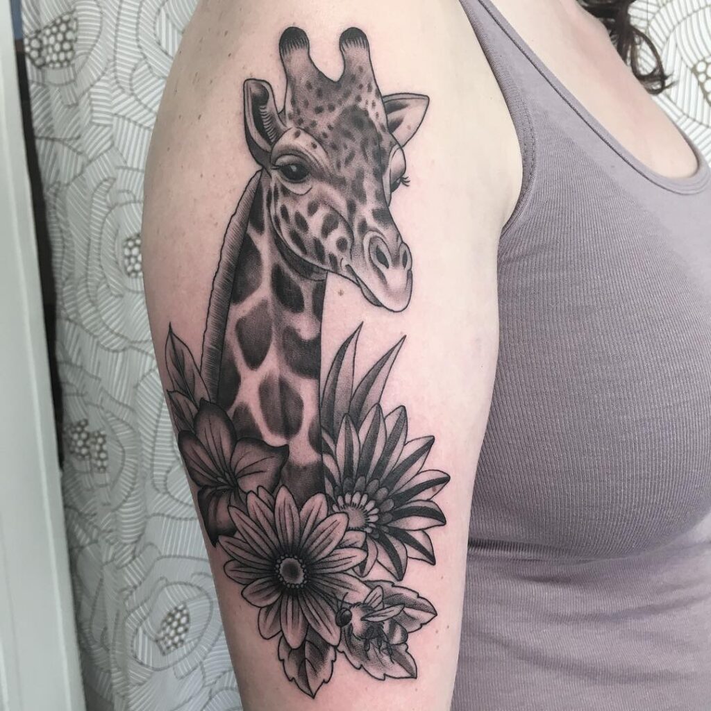 Tattoo of a giraffe on the shoulder for women