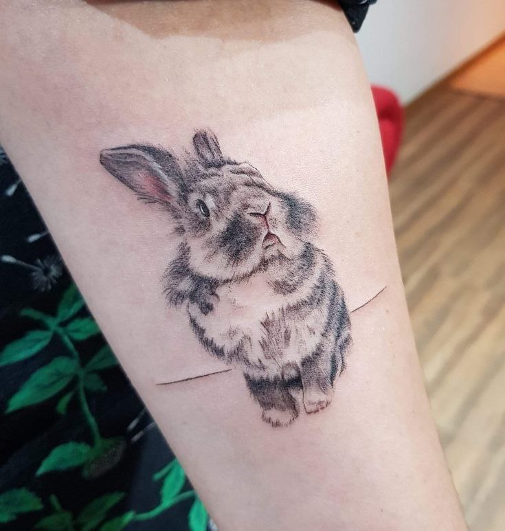 Tattoo of a hare (rabbit) on the forearm for women