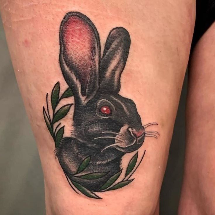 Tattoo of a hare (rabbit) on the hip for women