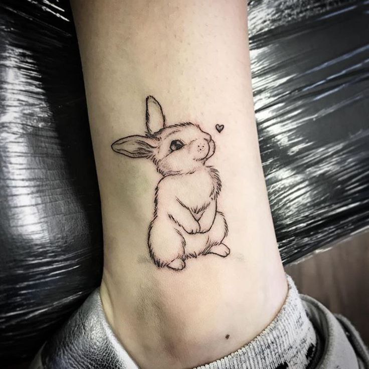 Tattoo of a hare (rabbit) on the leg for women