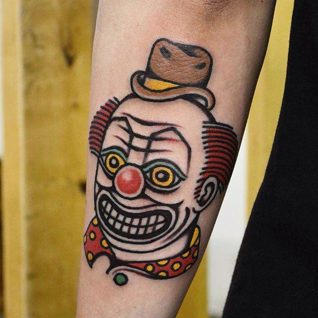 Tattoo of a clown on the forearm for men